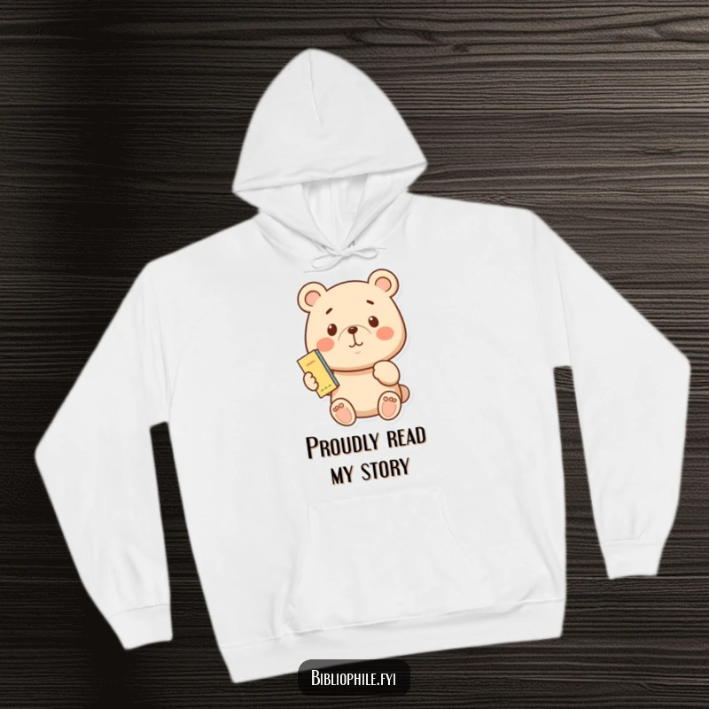 Funny, proud bear character holding a bookmark, depicted on a soft, warm hoodie for readers.